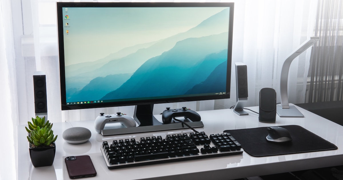 Professional working at a desk with a laptop, ready for voice dictation