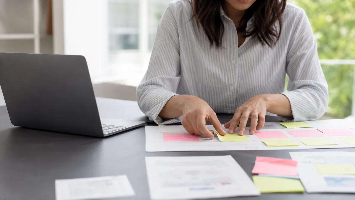 UX researcher reviewing interview notes on a laptop